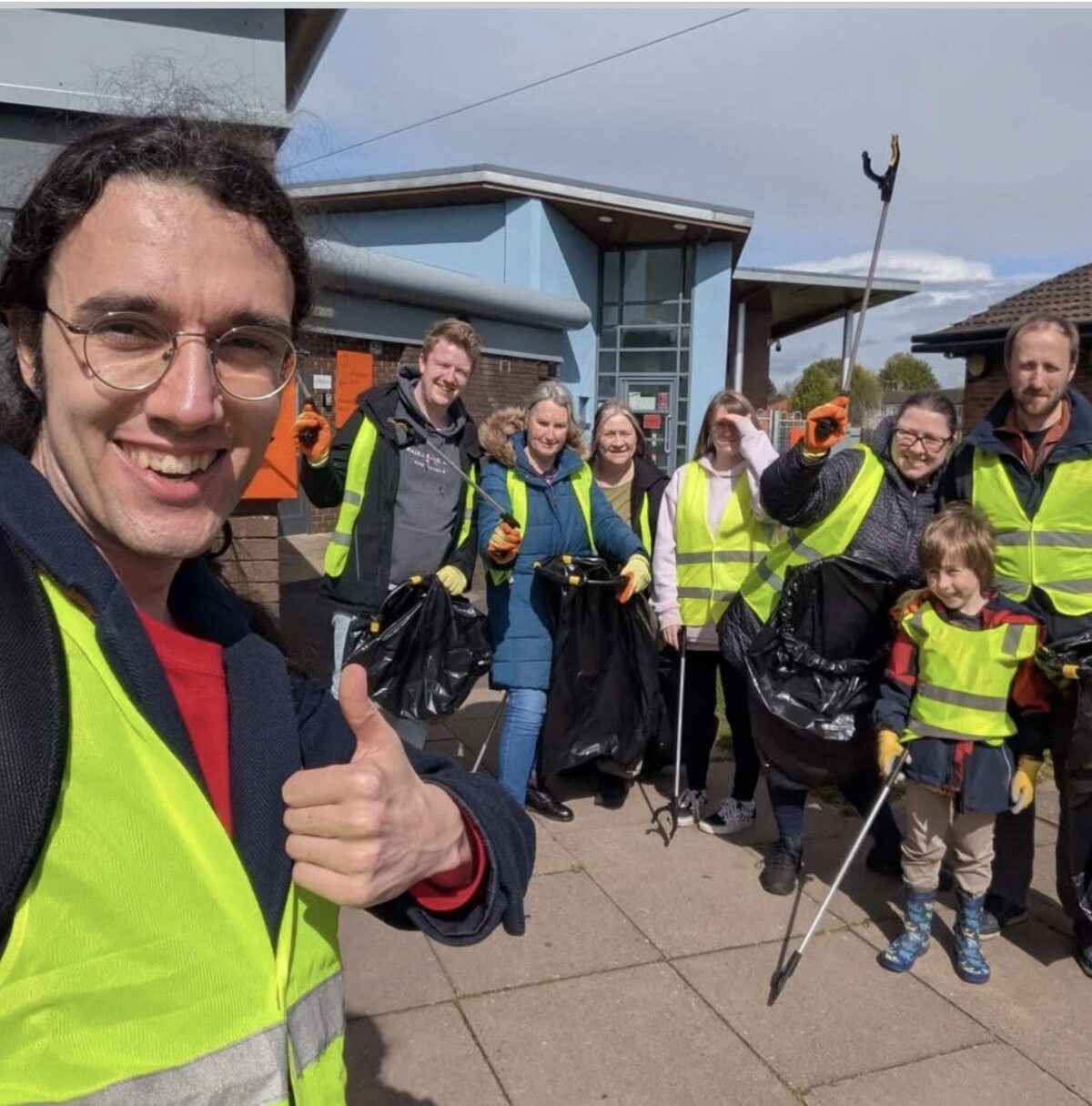  Kimberley and volunteers in high-vis vests during a community litter pick, giving a thumbs up.